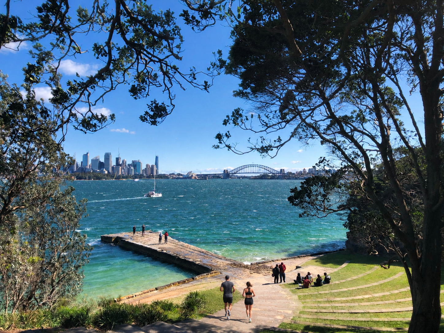 Two runners heading down to Sydney Harbour on the grounds of Taronga Zoo on the Balmoral to Taronga route